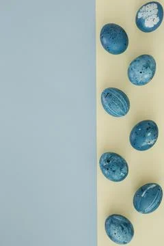 Creative layout of Easter blue eggs on a two-tone background with copy space on Stock Photos