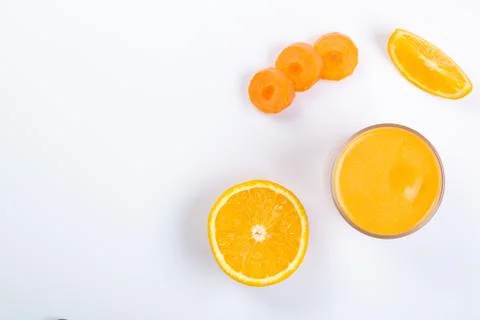Creative layout of fresh orange and carrot smoothie Stock Photos