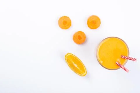 Creative layout of fresh orange and carrot smoothie Stock Photos