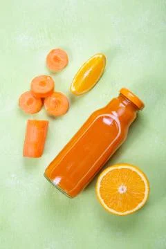Creative layout of fresh orange and carrot smoothie Stock Photos