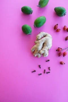 Creative layout of ginger,feijoa and rose hips on a colored background. Flat lay Stock Photos