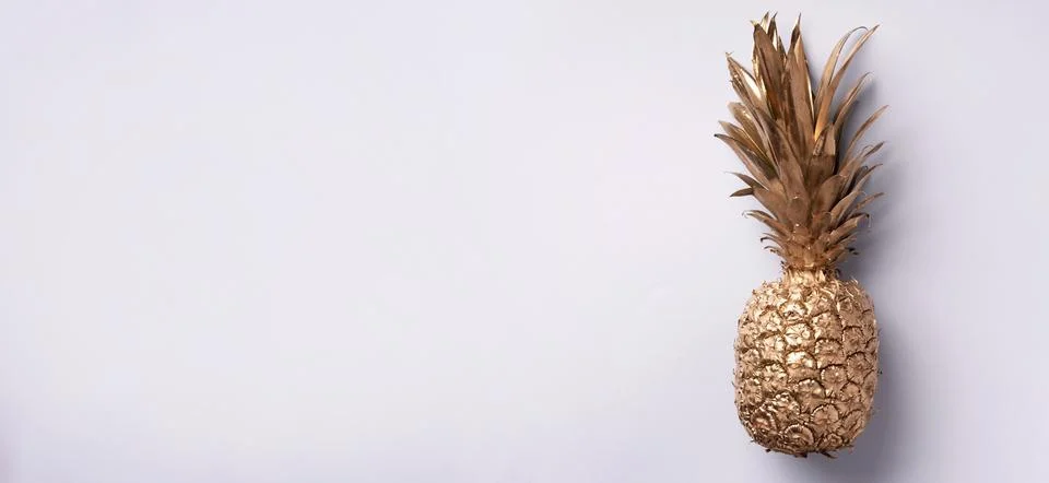 Creative layout. Gold pineapple on grey background with copy space. Top view Stock Photos