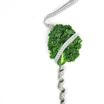 Creative layout kale with measuring tape concept diet, healthy lifestyle, die Stock Photos