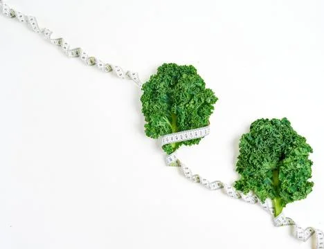 Creative layout kale with measuring tape, concept diet, healthy lifestyle, di Stock Photos