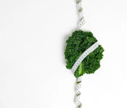 Creative layout kale with measuring tape, concept diet, healthy lifestyle, di Photos