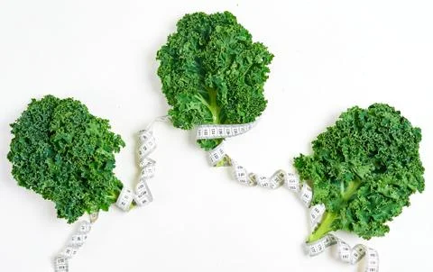 Creative layout kale with measuring tape, concept diet, healthy lifestyle, di Photos