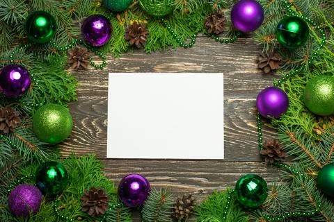 Creative layout made of Christmas tree branches with paper card note. Flat la Stock Photos