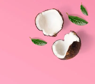 Creative layout made of coconuts and leaves. Coconut on pink background. Foto stock