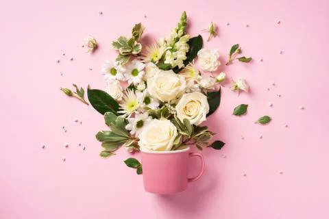 Creative layout made of coffee or tea cup with white flowers. Flat lay, top view Stock Photos