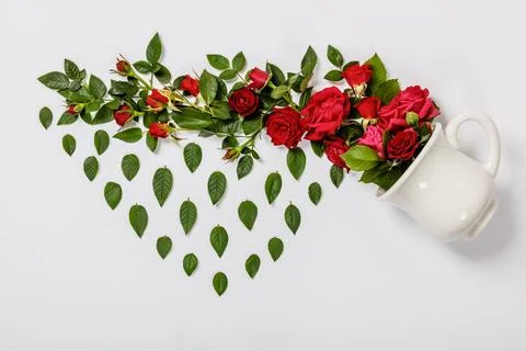 Creative layout made of coffee or tea cup with red roses on white background Stock Photos