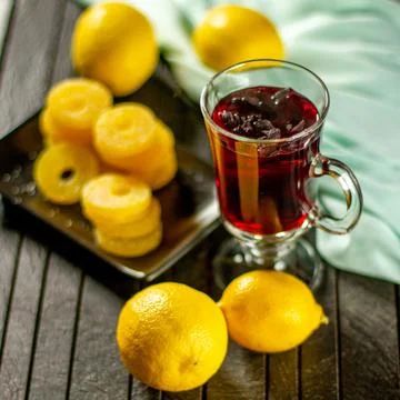 Creative layout made of cup of hibiscus tea and lemon on a table background. Top Stock Photos