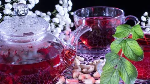 Creative layout made of cup of red tea and leafs. Tea time: cup of tea, carca Stock Photos