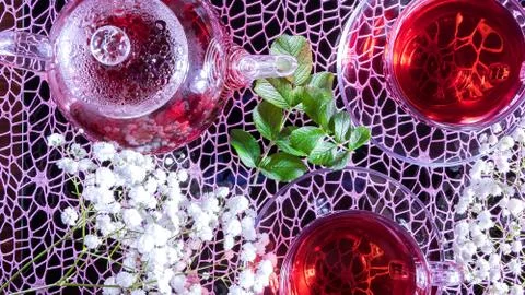 Creative layout made of cup of red tea and leafs. Tea time: cup of tea, carca Stock Photos