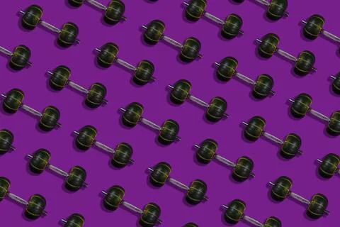 Creative layout made of dumbbells with a weight in the form of pumpkins, purple Stock Photos