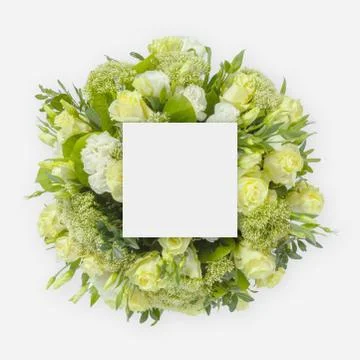 Creative layout made of flowers and leaves with paper card note. Flat lay Stock Photos