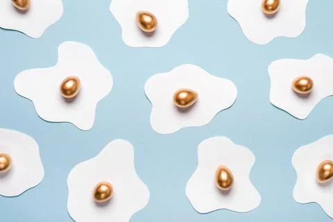 Creative layout made of fried eggs. Minimal pattern of paper protein and golden Stock Photos