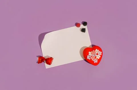 Creative layout made of fruity sweets and red heart with little pastel flower Stock Photos