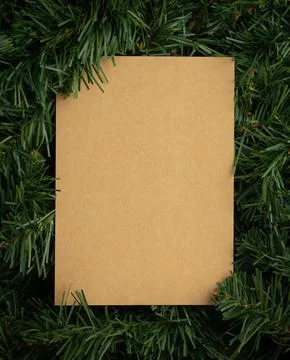 Creative layout made of leaves with craft paper card note. Flat lay. Nature.. Stock Photos