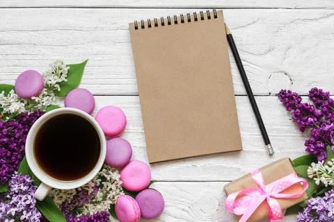 Creative layout made with lilac flowers, blank paper notebook, coffee cup a.. Stock Photos