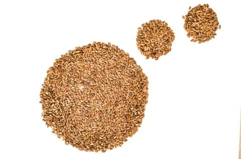 Creative layout made of organic flax seeds isolated on white background. Flat Stock Photos