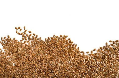 Creative layout made of organic flax seeds isolated on white background. Flat Stock Photos