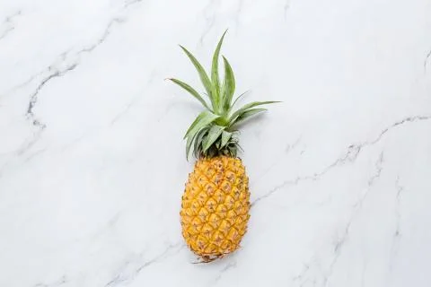 Creative layout made of pineapple on white marble background. Tropical flat l 스톡 사진