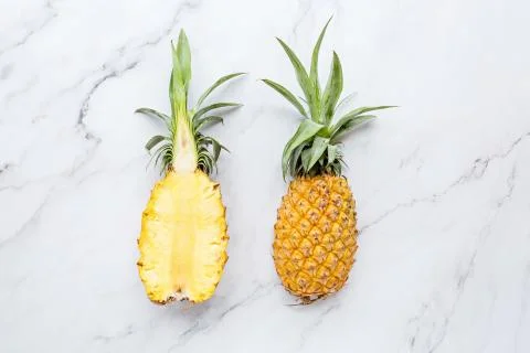Creative layout made of pineapple on white marble background. Tropical flat l Stock Photos