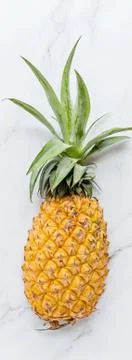 Creative layout made of pineapple on white marble background. Tropical flat l Stock Photos