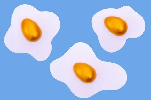 Creative layout made of scrambled eggs with decorated golden Easter eggs on a 库存照片