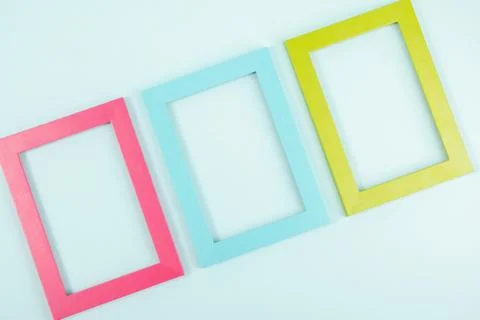 Creative layout made of three bright colored frames on blue background. Flat  Stock Photos