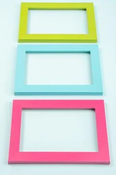 Creative layout made of three bright colored frames on blue background. Flat  Stock Photos