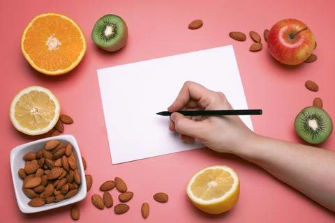 Creative layout made of various fruits and nuts with white paper sheet. Flat  Stock Photos