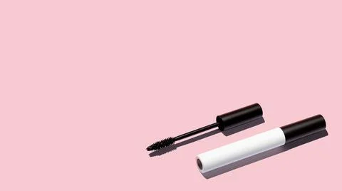 Creative layout of mascara on pink background. Make up products. Copy space. Stock Photos