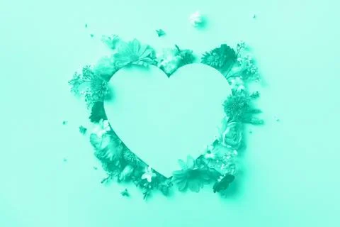 Creative layout with mint flowers, paper heart over mint color background. Top Stock Photos