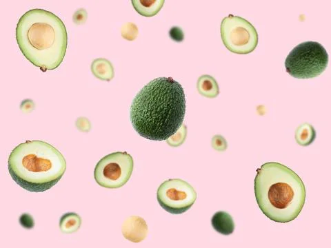 Creative layout with ripe flying avocado halves on pink background. Stock Photos