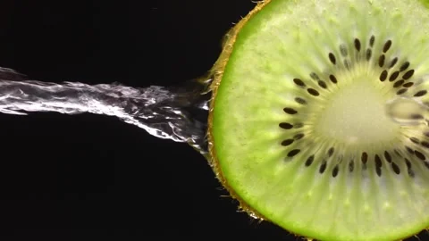 Creative layout of sliced kiwi and water. Splashes on black background. Stock-Footage 251911290
