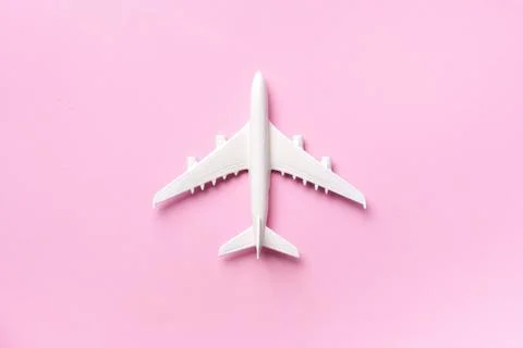Creative layout. Top view of white model plane, airplane toy on pink pastel Stock Photos
