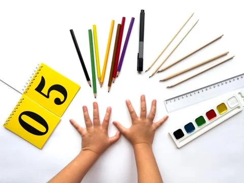 Creative learning: child's hands with art supplies and calendar Stock Photos
