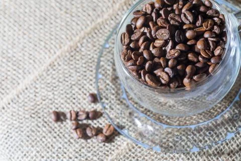 Creative lifestyle composition: aromatic coffee beans in a blue Fotos de archivo