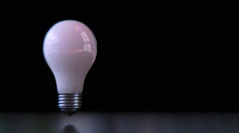 Creative Light - Light bulb comes in and turns on. Alpha included Stock Footage