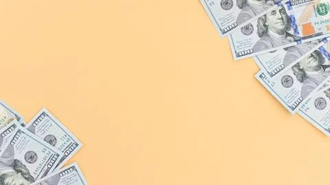 Creative Light Peach Background with Scattered Hundred Dollar Bills for Stock Photos