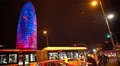Creative light show on Torre Agbar skyscraper, active traffic in night Barcelona 4k or 4k+ Resolution