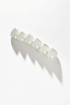 Creative line from plaster inverted hearts with long shadows. Stock Illustration