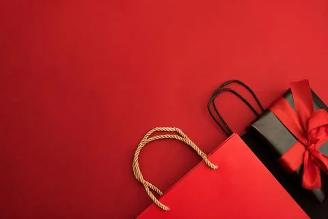 Creative look, two red and black gift boxes and a red shopping bag on a red Stock Photos