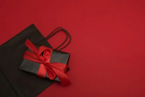 Creative looking gift box and black shopping bag.Black Friday, discounts, sales Stock Photos