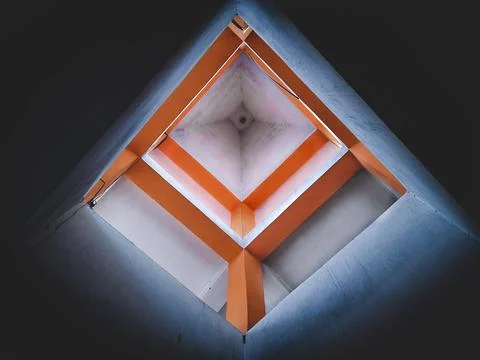 Creative low angle view of a building structure creating a geometric shape. Stock Photos