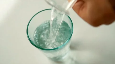 Creative macro slow motion video of white wine pouring into a glass. Soda ble Stock Footage 265846971