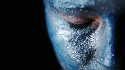Creative makeup woman face blue glitter paint eyes Stock Footage 124776603