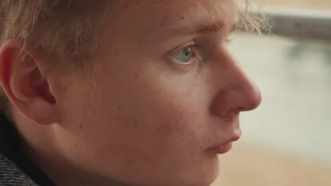 Creative male portrait captured inside observing beyond glass. An imaginative Stock Footage 332922972