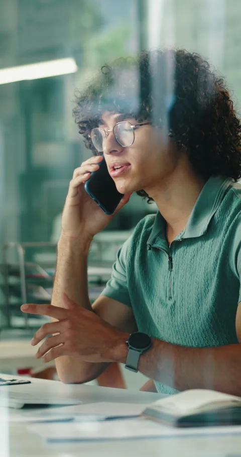 Creative, man and discussion in glass office with phone call, planning and Stock Footage 336774710
